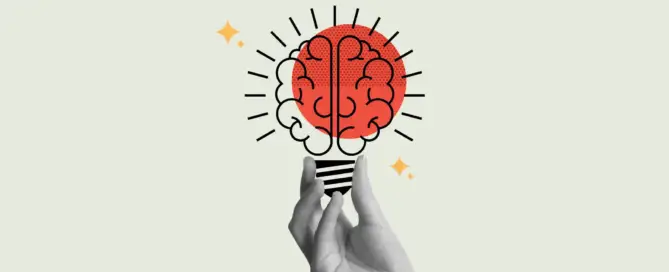 Imagem mostrando uma mão segurando o desenho de uma lâmpada em formato de cérebro representando o gatilho mental da identificação.